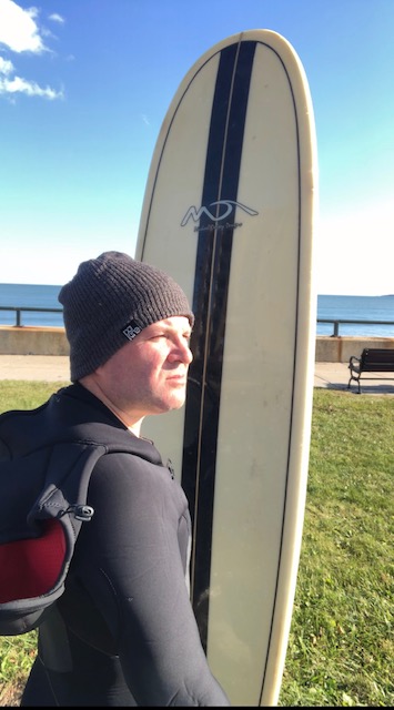Andrew with a surfboard