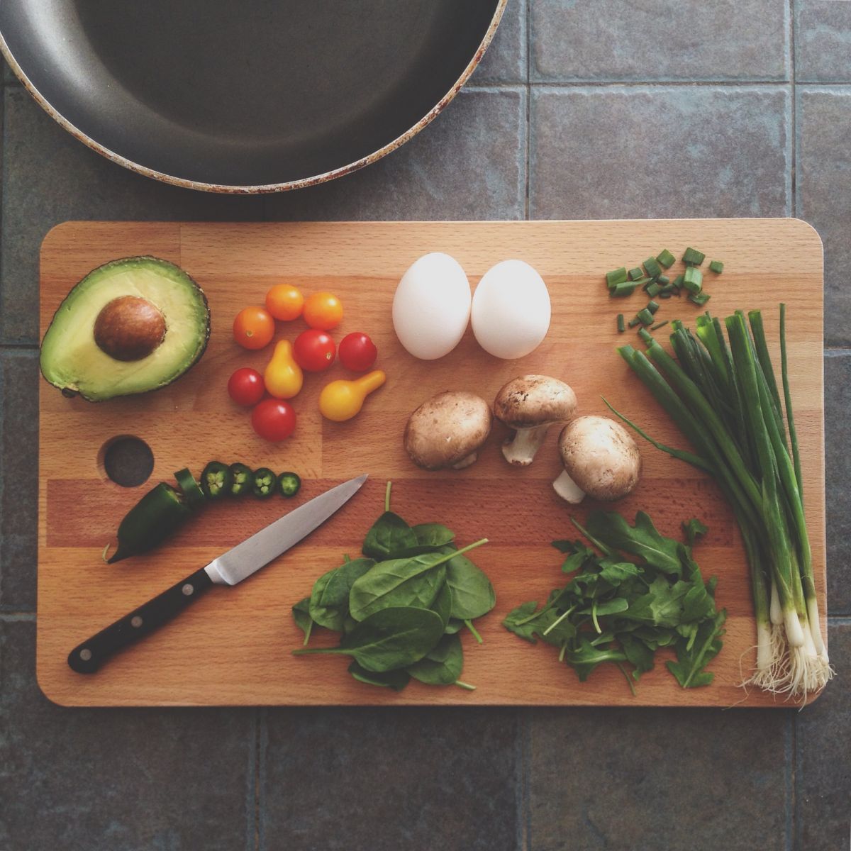 cutting board with vegetables and eggs